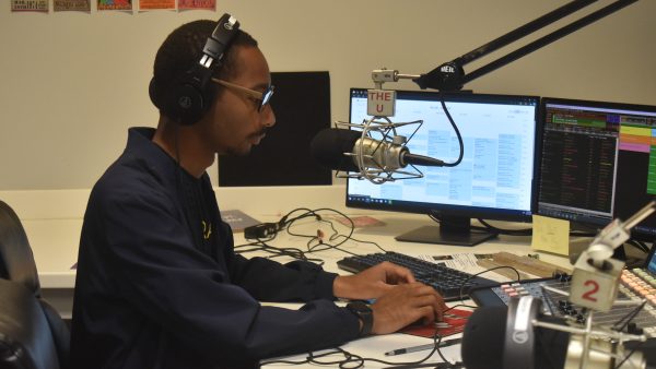 person using switchboard in radio recording booth