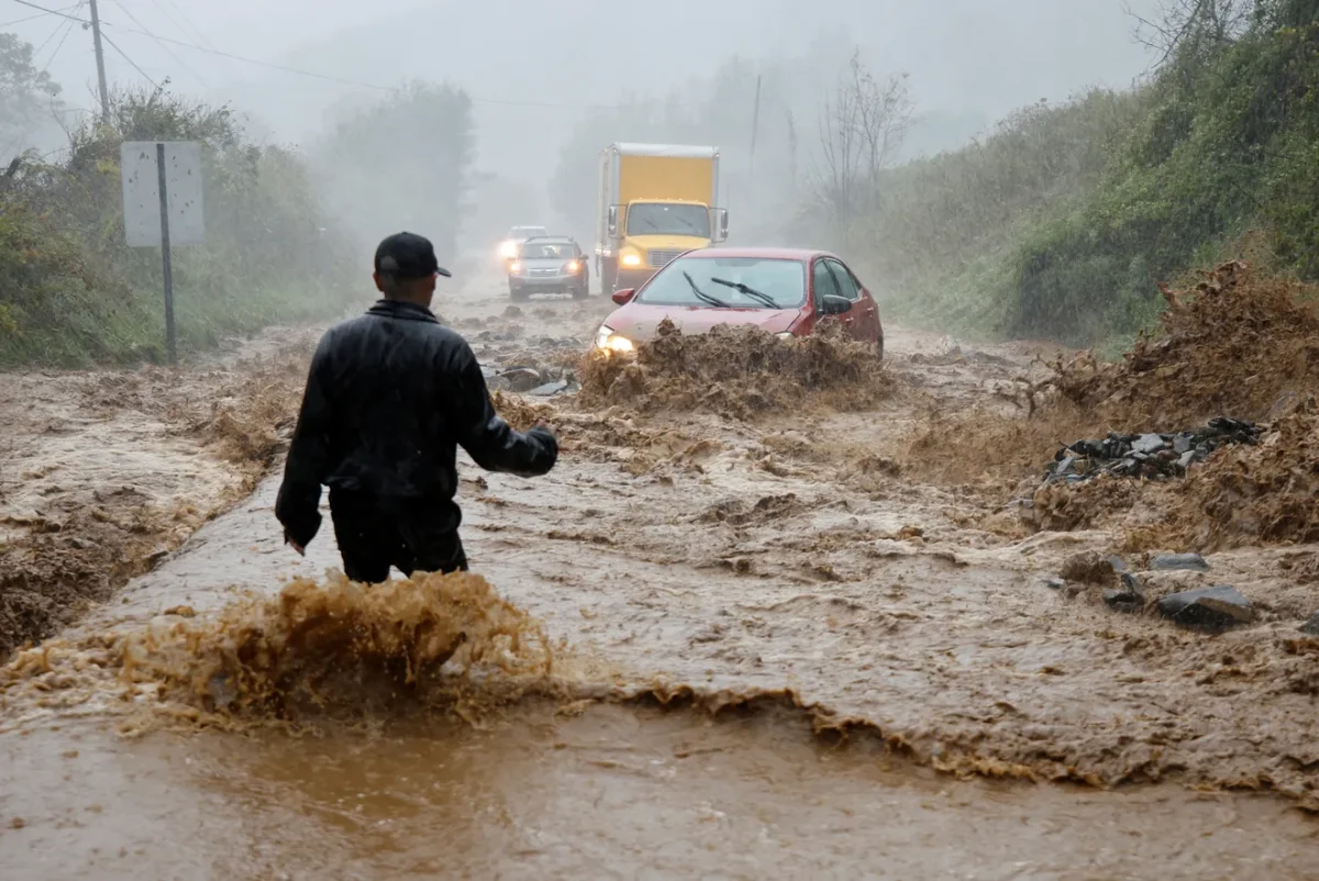 A person stands in knee-deep waters in Boone, N.C., during Hurricane Helene.