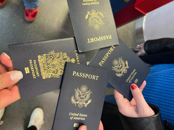 four passports held by students, from a bird's eye view