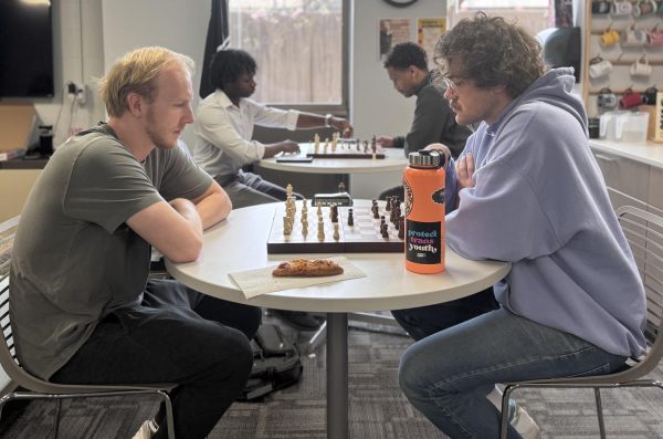 Four students playing chess.