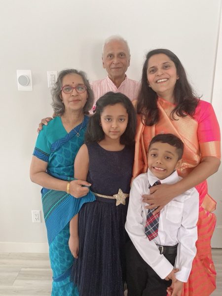 Namita standing with her family