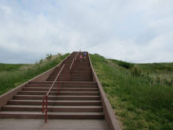 staircase over a grass covered dirt mound